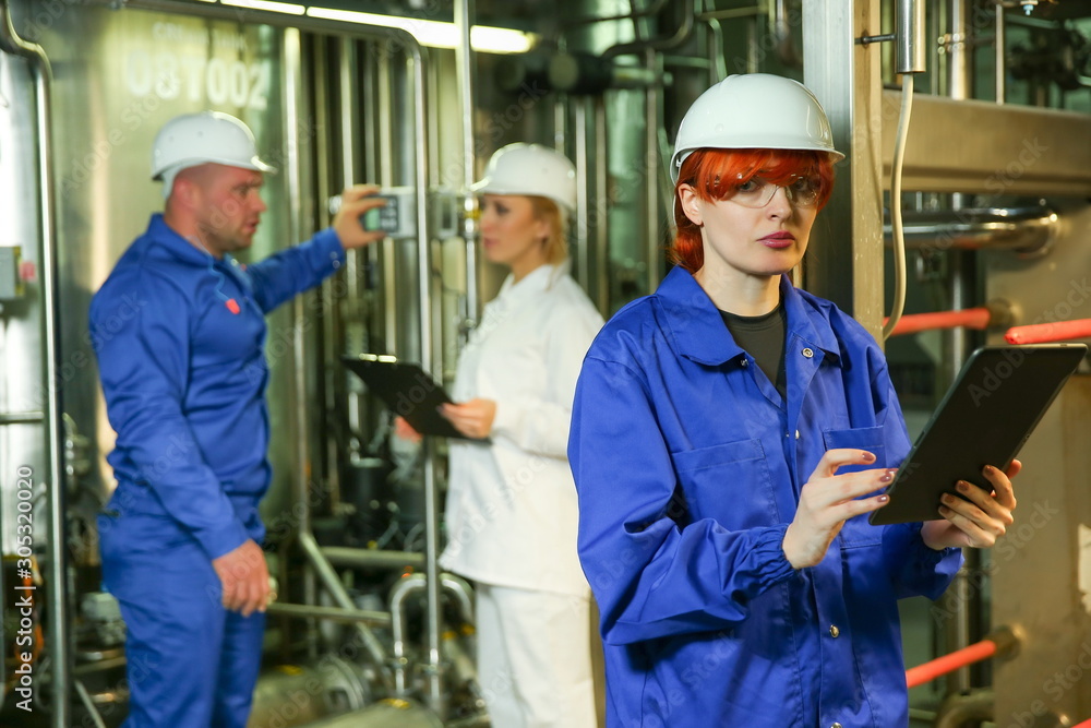 team of food factory workers at work. worker against other workers on a product factory team of food factory workers at work. worker against other workers on a product factory