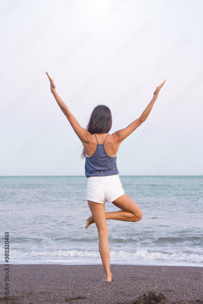 Young athlete woman practicing yoga on the beach Young athlete woman practicing yoga on the beach