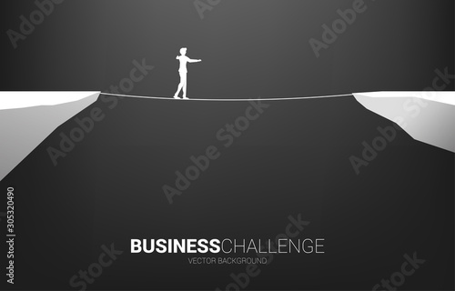 Silhouette of businessman walking on rope walk way.Concept for business risk and challenge in career path