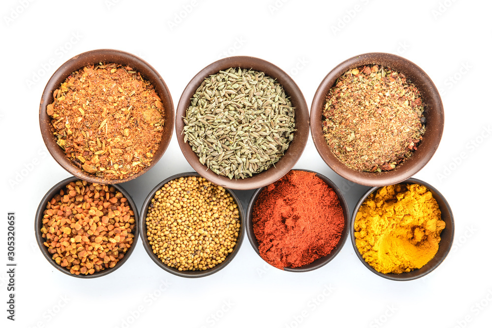 Bowls with different spices on white background Bowls with different spices on white background