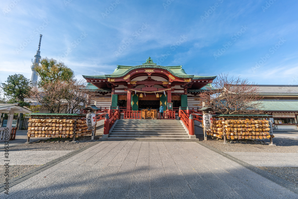 Honden (Main Hall) of Kameido Tenjin Shinto Shrine and Tokyo Sky Tree in the Background. Built in 1646 in honor of Sugawara no Michizane. Tokyo, Japan