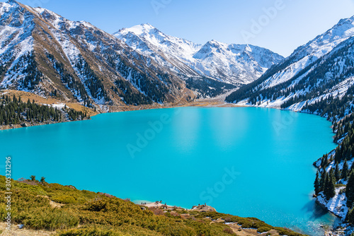 Lake with turquoise water surrounded by a mountain massif. Big Almaty lake in the mountains. Kazakhstan