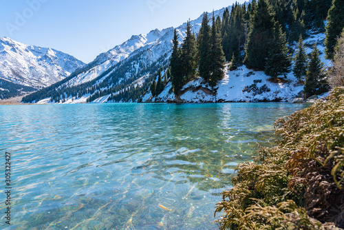 Lake with turquoise water surrounded by a mountain massif. Big Almaty lake in the mountains. Kazakhstan