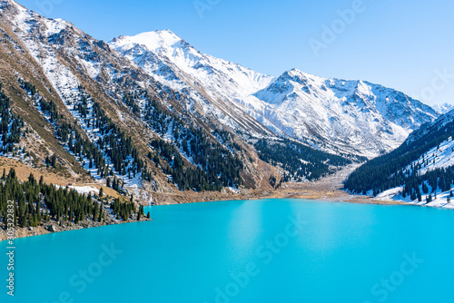 Lake with turquoise water surrounded by a mountain massif. Big Almaty lake in the mountains. Kazakhstan