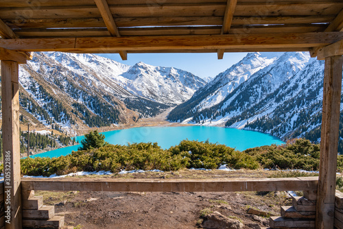 Lake with turquoise water surrounded by a mountain massif. Big Almaty lake in the mountains. Kazakhstan
