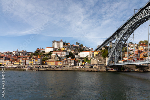 Landscape of Porto, Portugal with Douro River, city skyline, and bridge under blue sky © Isabelle