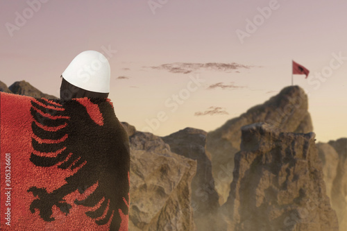 side view of man covered with fluffy albanian flag in front of blurred mountains to celebrate. Concept celebrate the national holiday of november 28th