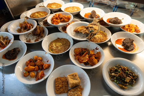 The famous "Nasi Padang" in Indonesia. Rice is served with many dishes like chicken, beef, mix vegetables and eggs.