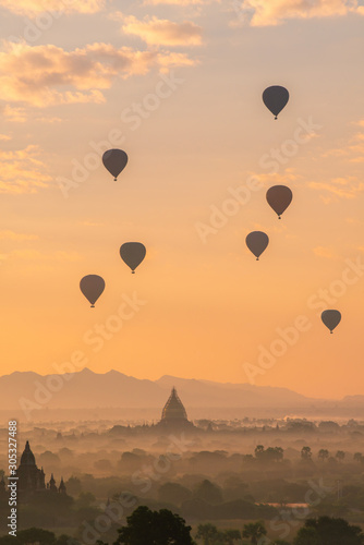Group of the hot air balloons flying over ancient pagoda in Bagan plain at dawn. Bagan now is the UNESCO world heritage site and the first kingdom of Myanmar. © boyloso