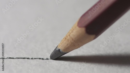 Artists hands drawing wooden pencil writes line on paper. Education handwriting exercise with red pencil. Dynamic closeup shot filmed in 4k UHD 2160p