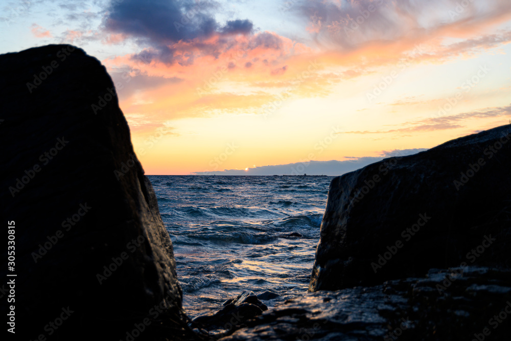 sunset framed between two large rocks