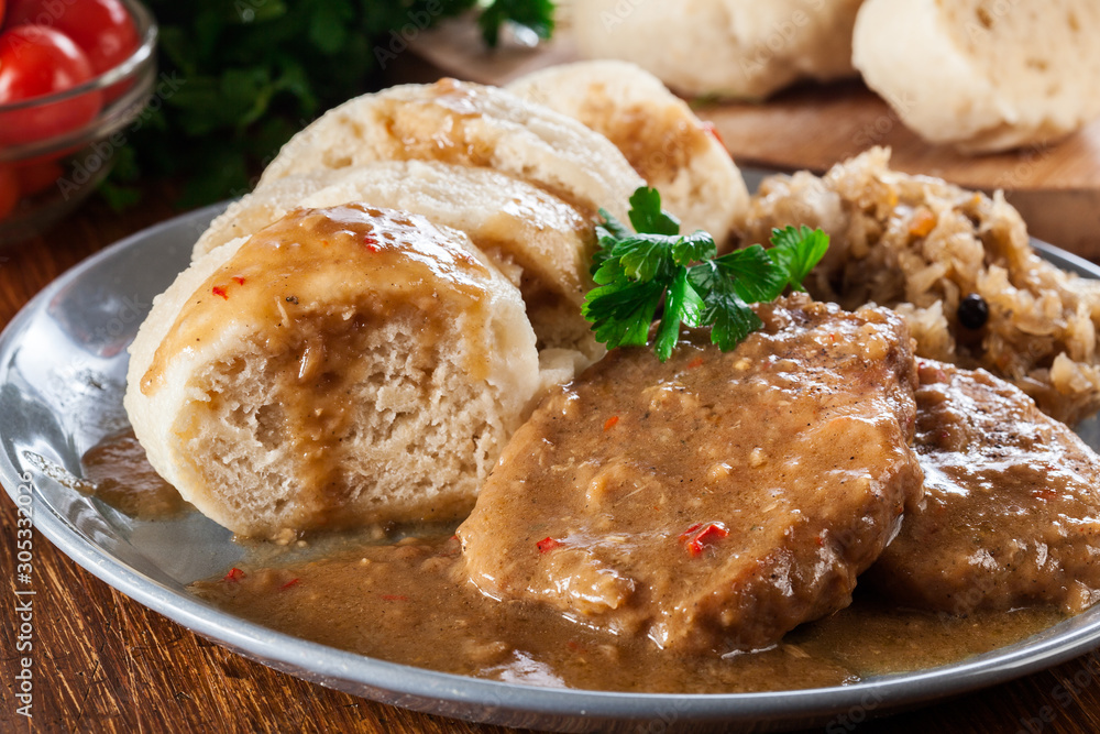 Pork loin in gravy with bread dumplings and sauerkraut Pork loin in gravy with bread dumplings and sauerkraut