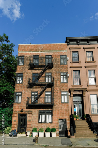 Brownstone facades & row houses at sunset in an iconic neighborhood of Brooklyn Heights in New York City