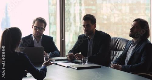 Wallpaper Mural Businesswoman job applicant convincing employers businessmen during job interview Torontodigital.ca
