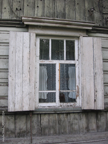 old wooden rural house with an open window  historical monument