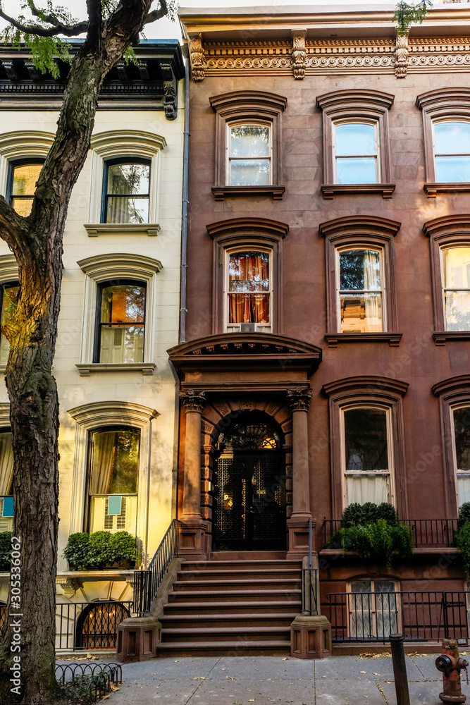 Brownstone facades & row houses at sunset in an iconic neighborhood of Brooklyn Heights in New York City