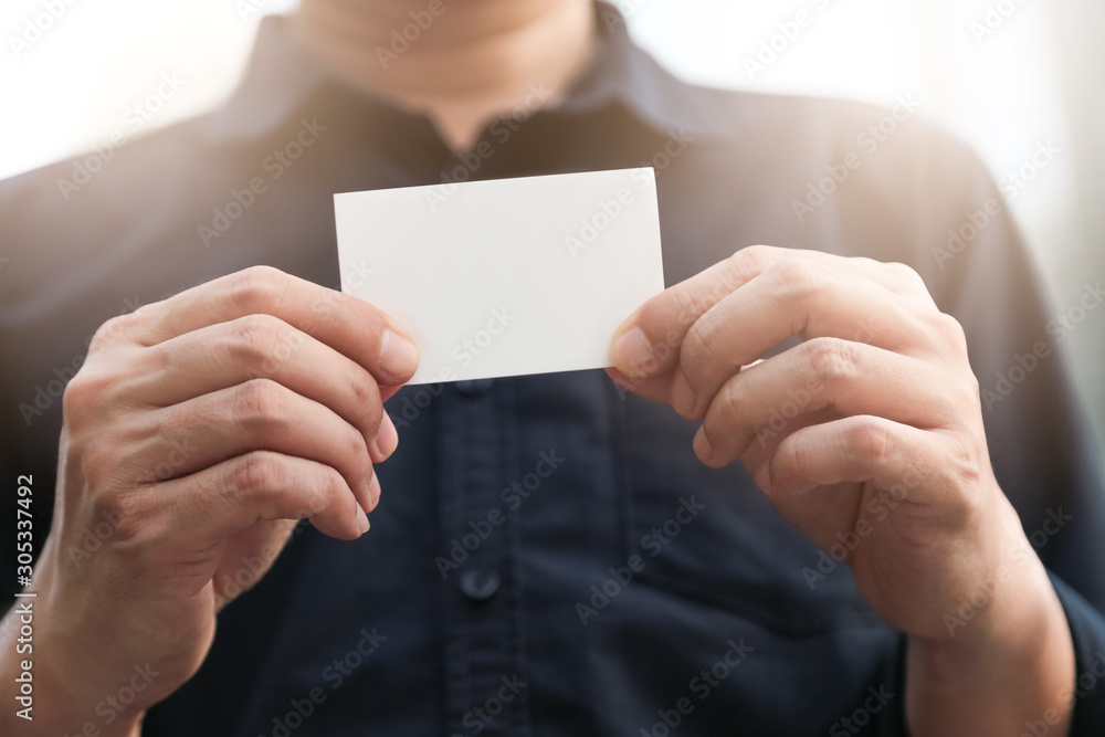 Fototapeta premium Confident male business executive with empty white business card
