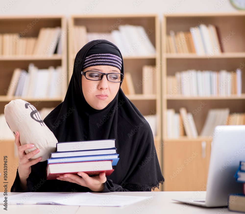 Muslim girl in hijab studying preparing for exams Muslim girl in hijab studying preparing for exams