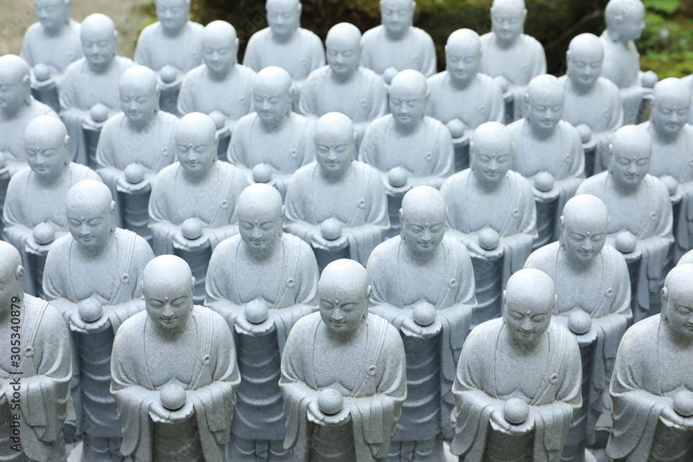 Fototapeta premium roll of Jizo Bodhisattva statues or statutes of baby buddha sat Hase-dera temple in Kamakura, Japan