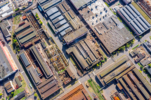 aerial top view of city industrial district. heavy industry manufacturing buildings with rusty roofs