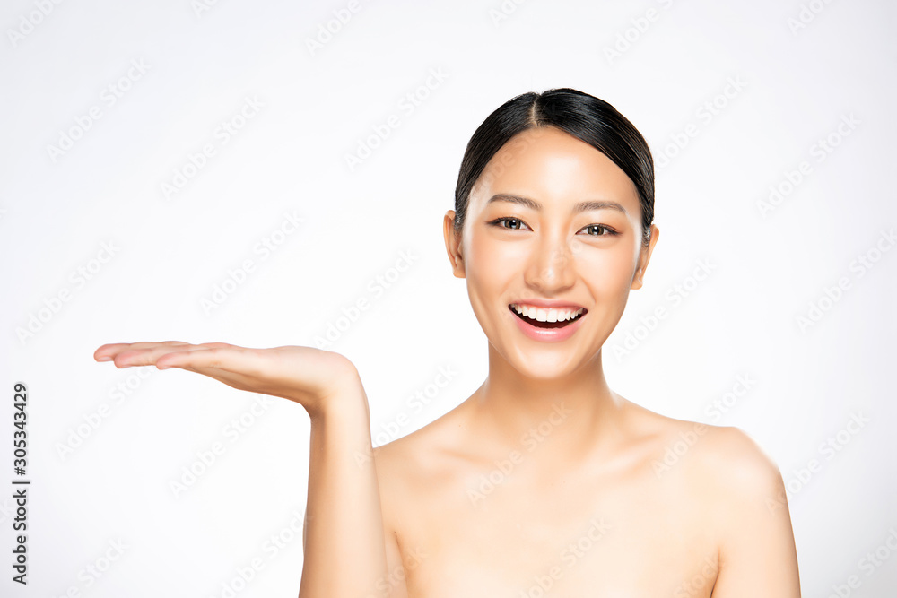 Beautiful Attractive Charming Asian young woman smile with white teeth open hand palm for display cosmetics product. Beautiful Attractive Charming Asian young woman smile with white teeth open hand palm for display cosmetics product.