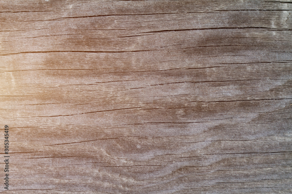 Fototapeta premium Old filthy pine board with cracks, toned sunlight. Wooden natural background.