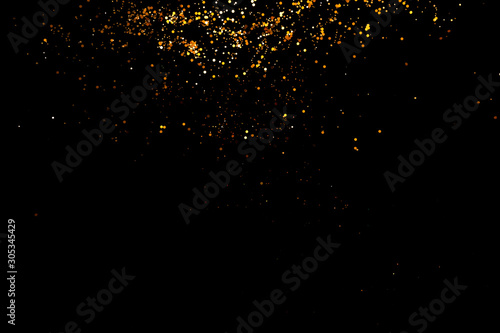 Golden sparkles, glitter on black background shine, New year concept.