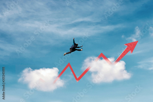 Success, achievement and business growth concepts. a man jumping over clouds with raising arrow