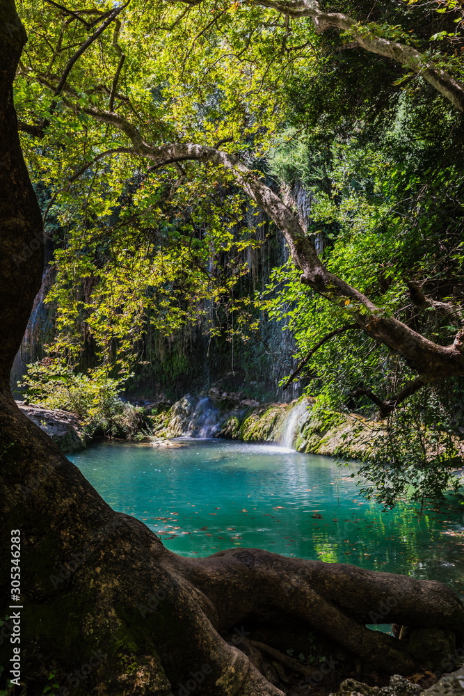 Fototapeta premium The Kursunlu Waterfall Nature Park in Antalya, Turkey. The waterfall is on one of the tributaries of the Aksu River and situated in the midst of a pine forest 