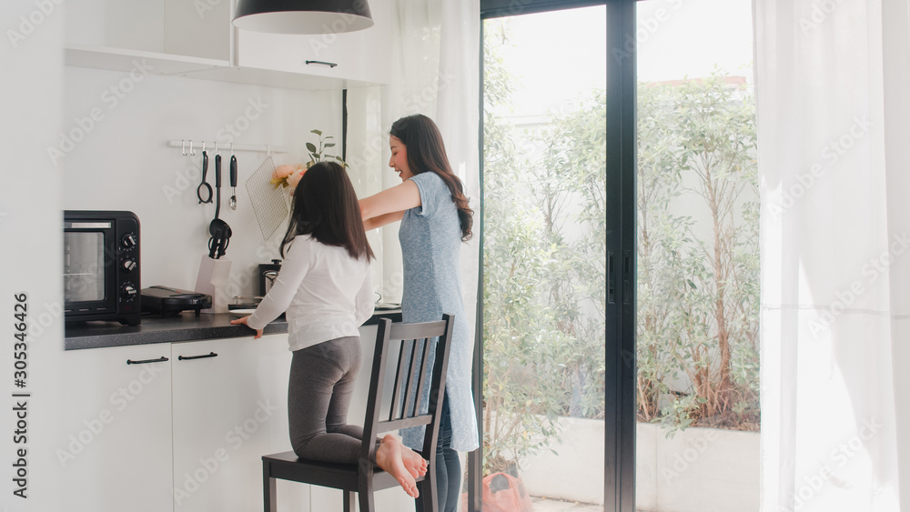 Young Asian Japanese Mom and Daughter cooking at home. Lifestyle women happy making pasta and spaghetti together for breakfast meal in modern kitchen at house in the morning concept. Young Asian Japanese Mom and Daughter cooking at home. Lifestyle women happy making pasta and spaghetti together for breakfast meal in modern kitchen at house in the morning concept.