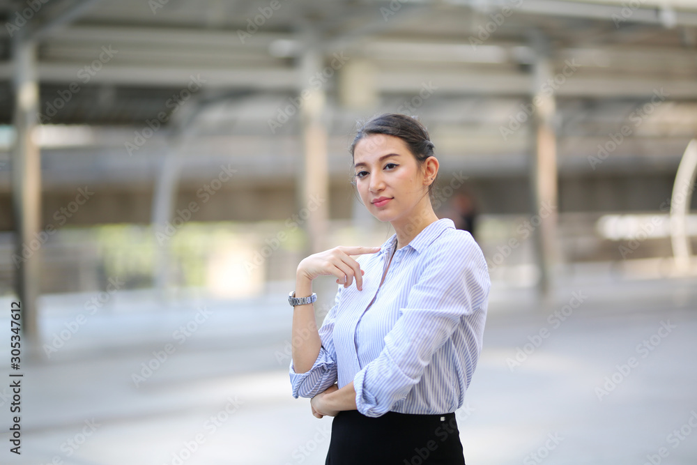 Portrait of smiling young beautiful business woman standing at outside. Portrait of smiling young beautiful business woman standing at outside.