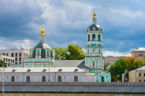 Moscow. Russia. Church of St.Nicholas on the Raushskaya embankment. Church on the embankment of the Moscow river. Church of St.Nicholas in Zayatsky. Golden domes against a gray sky. Religious building