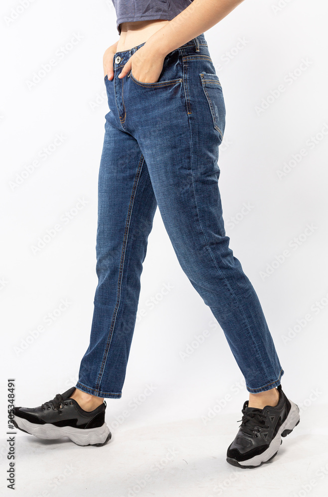 girl in jeans shows off jeans on white background close up, blue jeans girl in jeans shows off jeans on white background close up, blue jeans