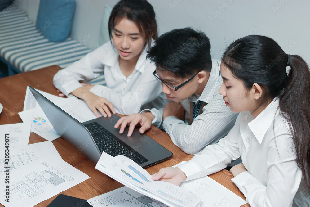 Teamwork business concept. Group of Asian people working with laptop together in modern office. Selective focus and shallow depth of field. Teamwork business concept. Group of Asian people working with laptop together in modern office. Selective focus and shallow depth of field.