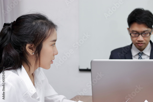 frustrated stressed Asian business female suffering from severe depression during meeting.