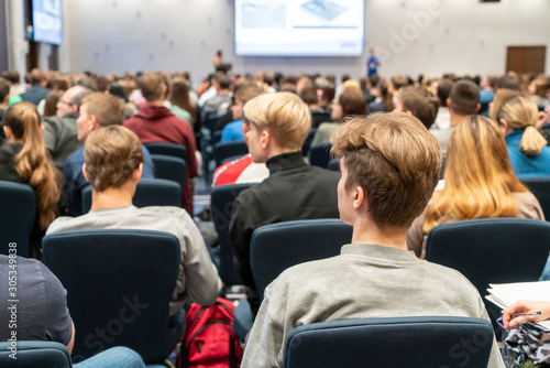 Image of a conference that takes place in a large conference room, workshop for young professionals, training in a large conference room, adult training