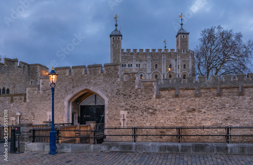 The wooden gate and exterior stone wall of the Tower of London in London England