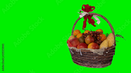 Many fruits in a basket with a green background for a New Year's gift