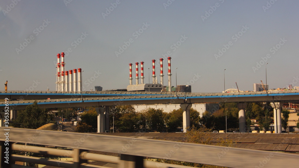 Moscow industrial cityscape - heating pipes on road 3rd transport ring background on Summer day