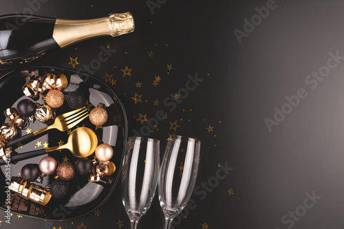 Christmas or New Year composition. Dinner arrangement. Champagne, glasses. Moody toning.