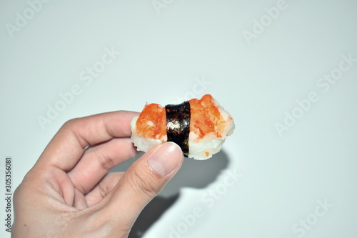 sushi in hand isolated on white background