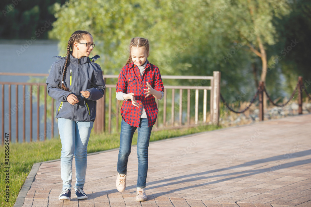 Two teenage girls spend some time outdoors. Two teenage girls spend some time outdoors.