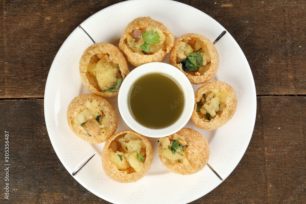 Tadeonal subcontinental street snack food chickpeas potato pani puri fuska with tamarind sauce Tadeonal subcontinental street snack food chickpeas potato pani puri fuska with tamarind sauce