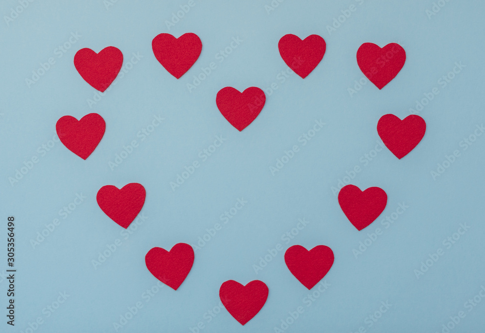 Valentine's Day blue background with red hearts. Valentine greeting card. Flat lay style. 