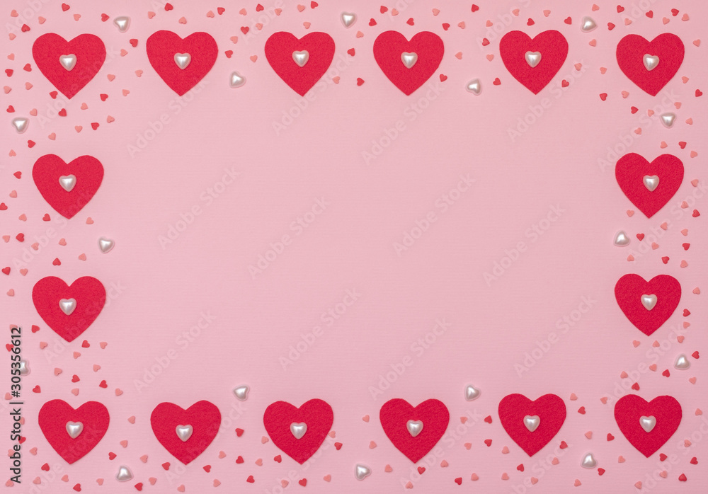 Valentine's Day pink background with red and pearl hearts. Valentine greeting card. Flat lay style.