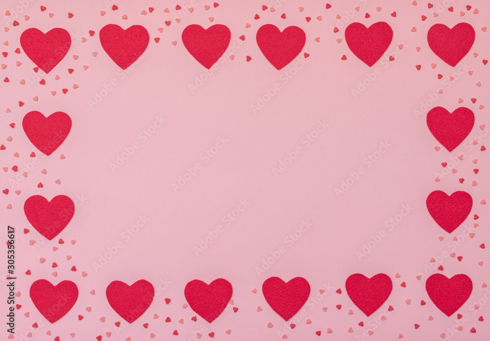 Valentine's Day pink background with red hearts. Valentine greeting card. Flat lay style.