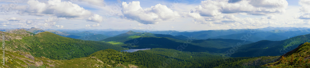 Panorama of distant mountains in the Ergaki Nature Park. Sunny summer day in the mountains of the Western Sayan