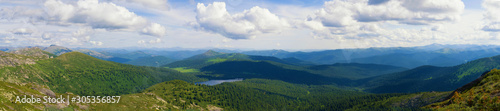 Panorama of distant mountains in the Ergaki Nature Park. Sunny summer day in the mountains of the Western Sayan