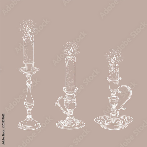 Hand drawn candle set. Burning candle in an old candlestick engraved in retro style. Vector illustration