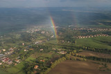 Aerial view of sown field landscape and population, a sunny day with rainbow
